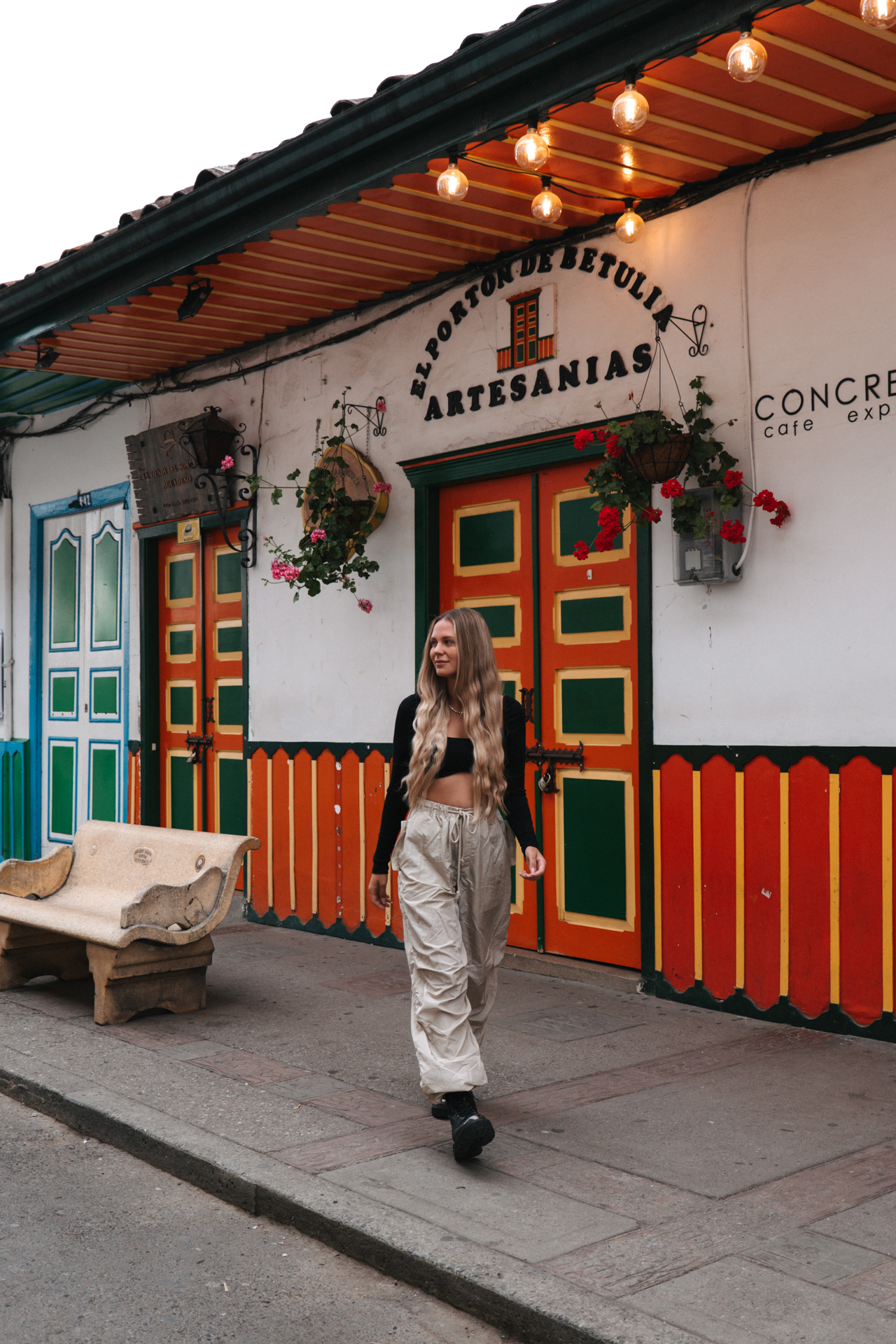 Woman walking Salento street with colorful colonial houses and vibrant doors