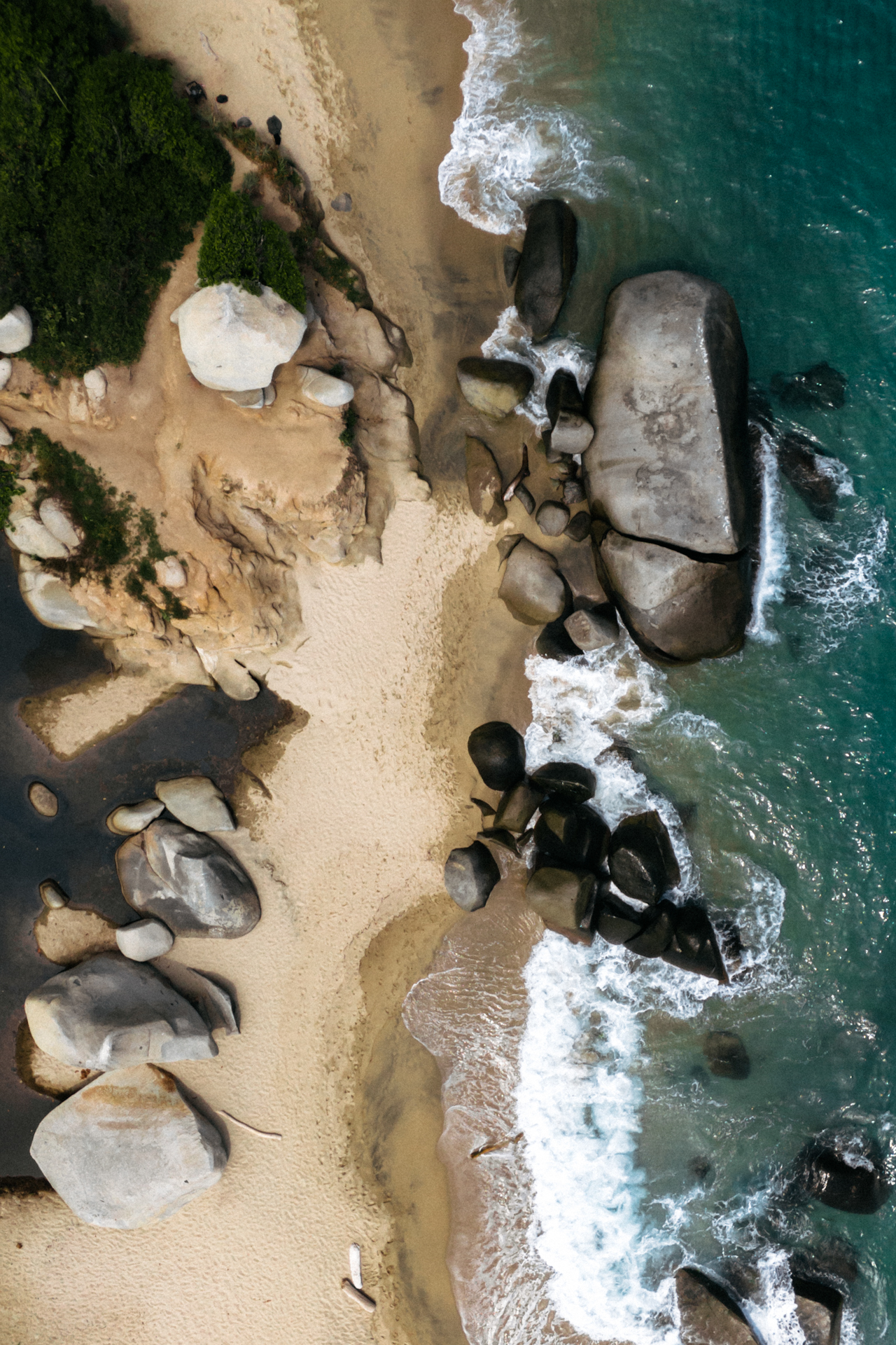Tayrona National Park aerial beach with rocks, turquoise water and tropical coastline