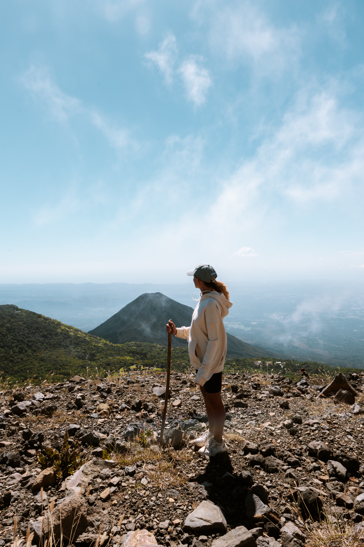 Hiker at the summit of Santa Ana Volcano hike overlooking a lush volcanic landscape