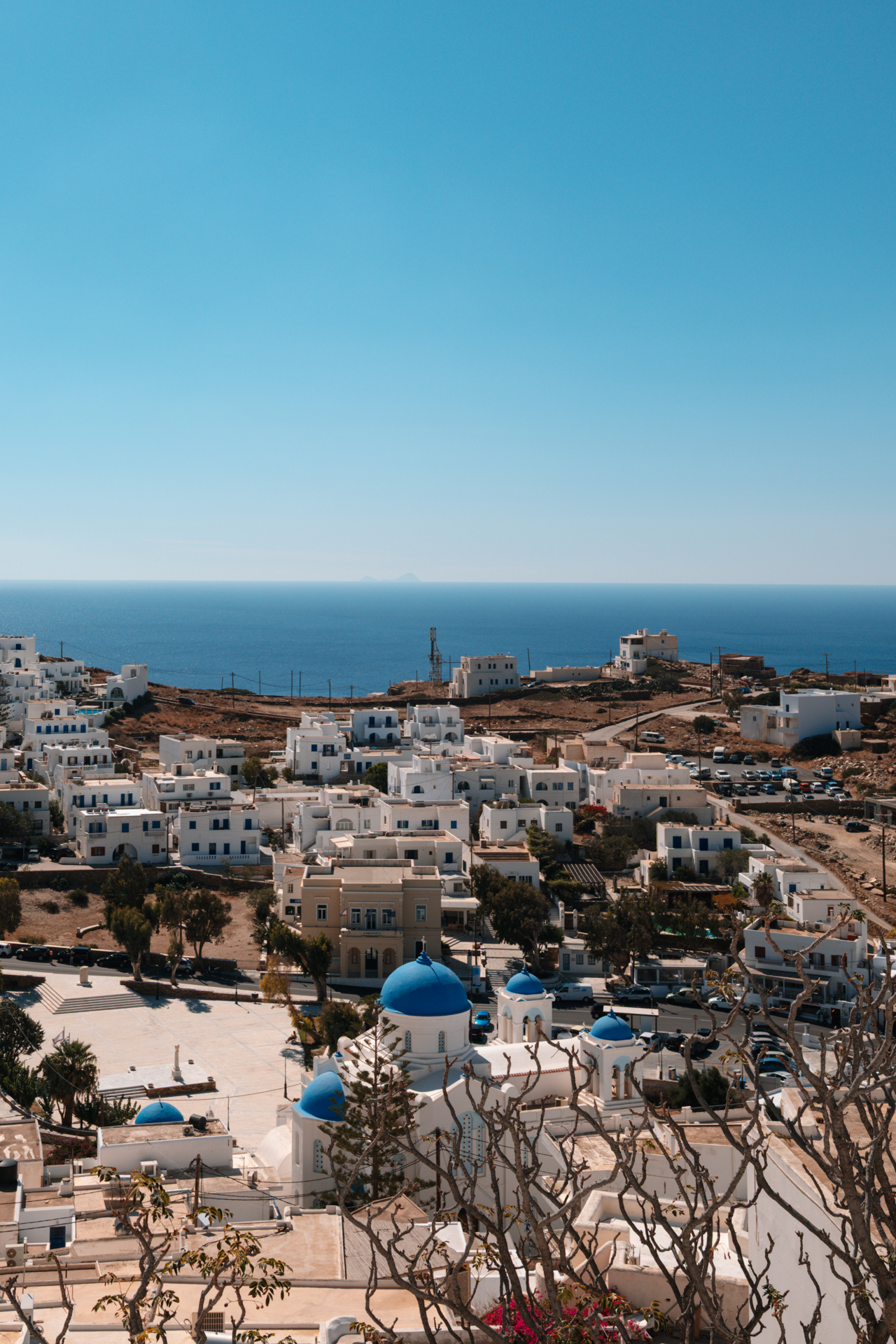 Church of Panagia Gremniotissa, Panoramic view over Chora, Ios with white houses, blue domes, and sea horizon
