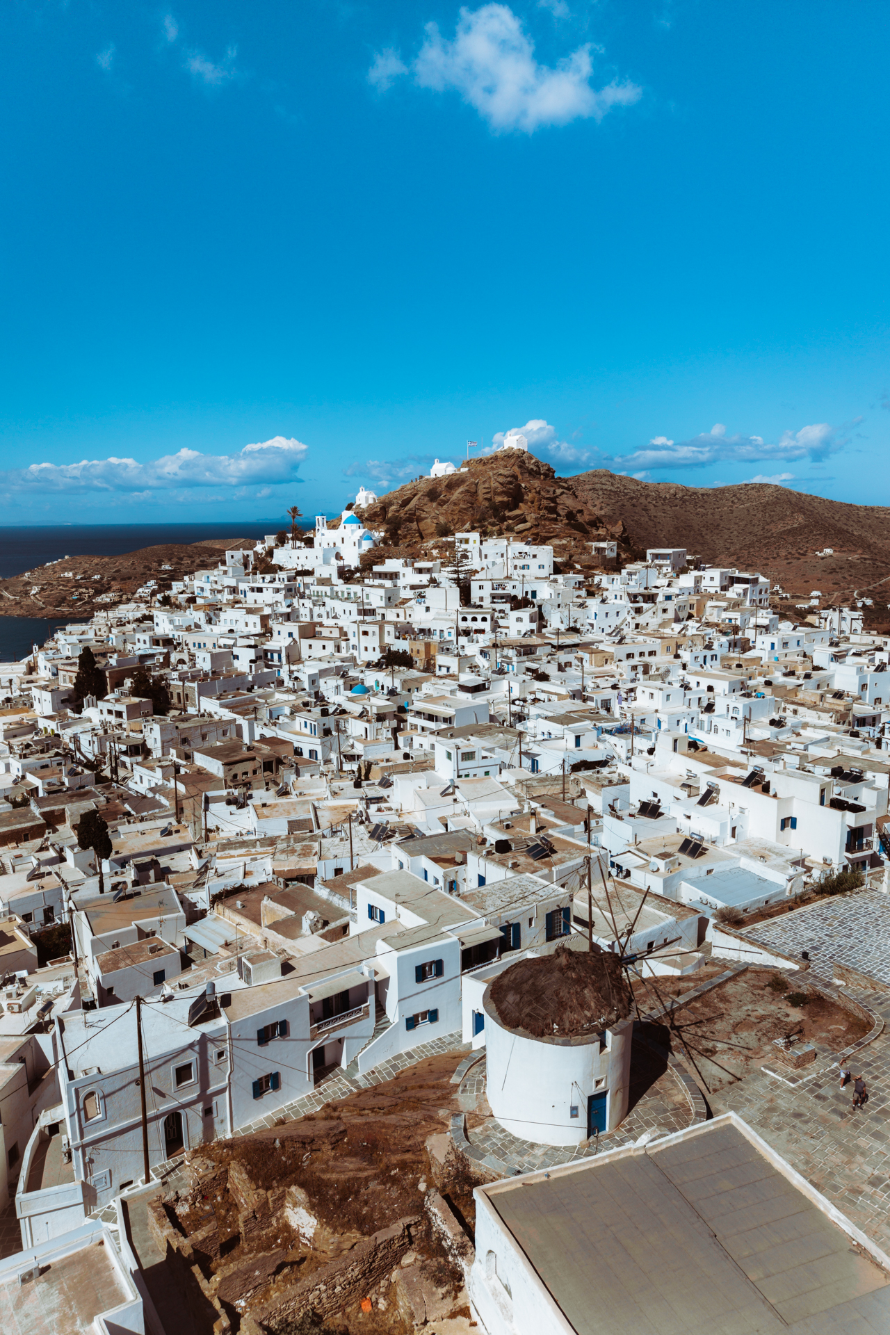 Panoramic view of Chora, Ios with white houses and traditional windmill