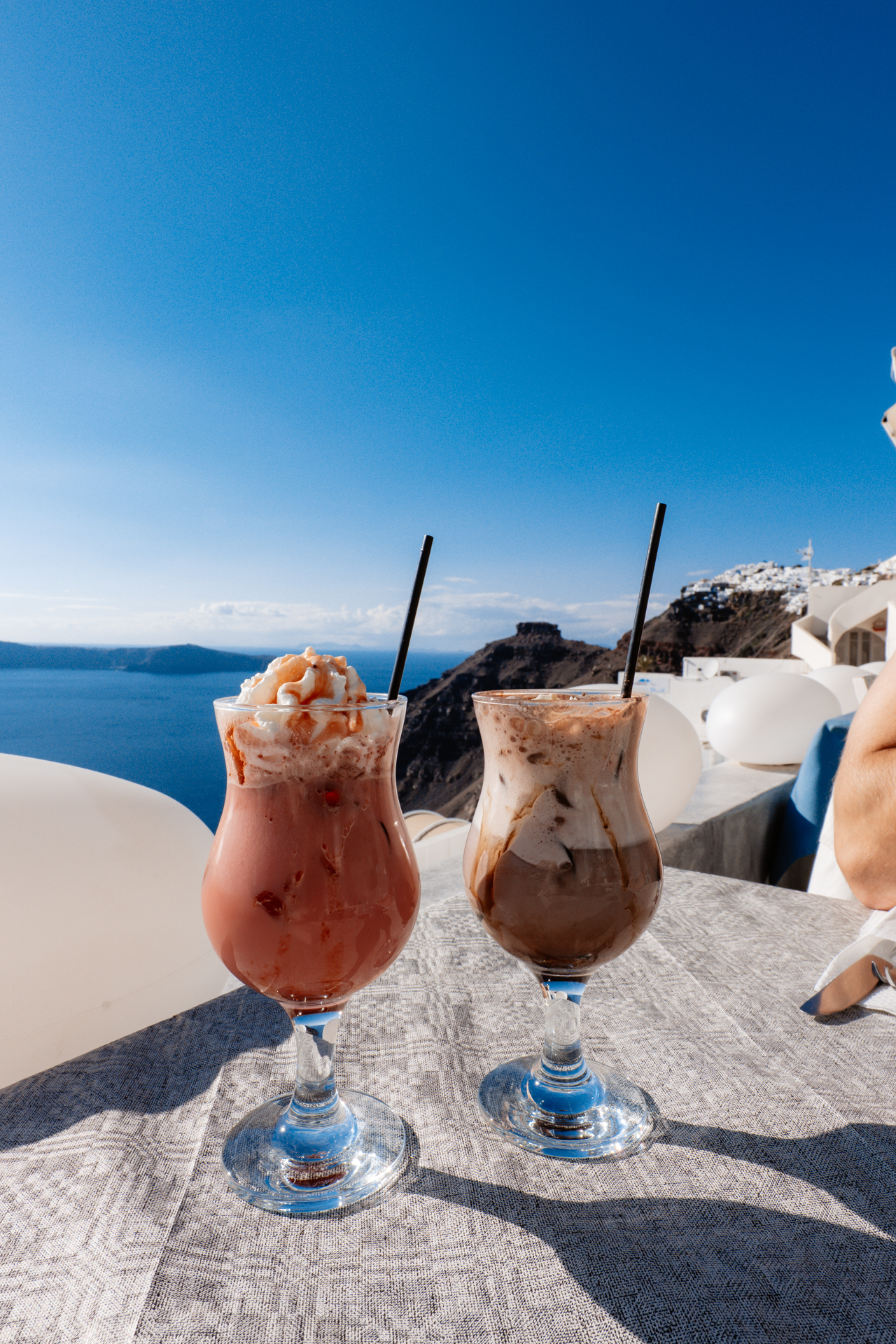 Cocktails with caldera view and cliffside restaurant terrace in Santorini