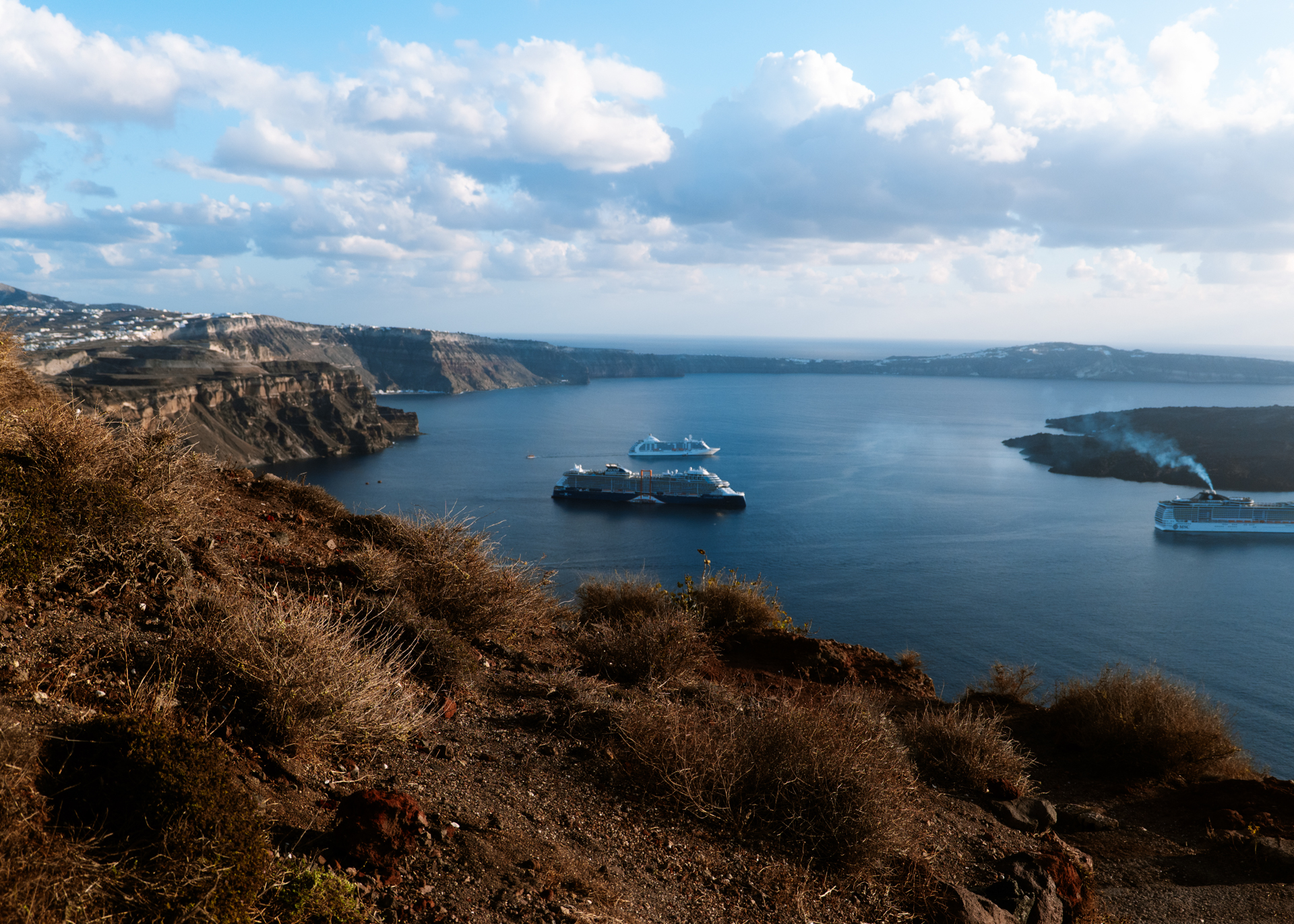 Santorini caldera view with cruise ships, volcanic cliffs and Aegean Sea