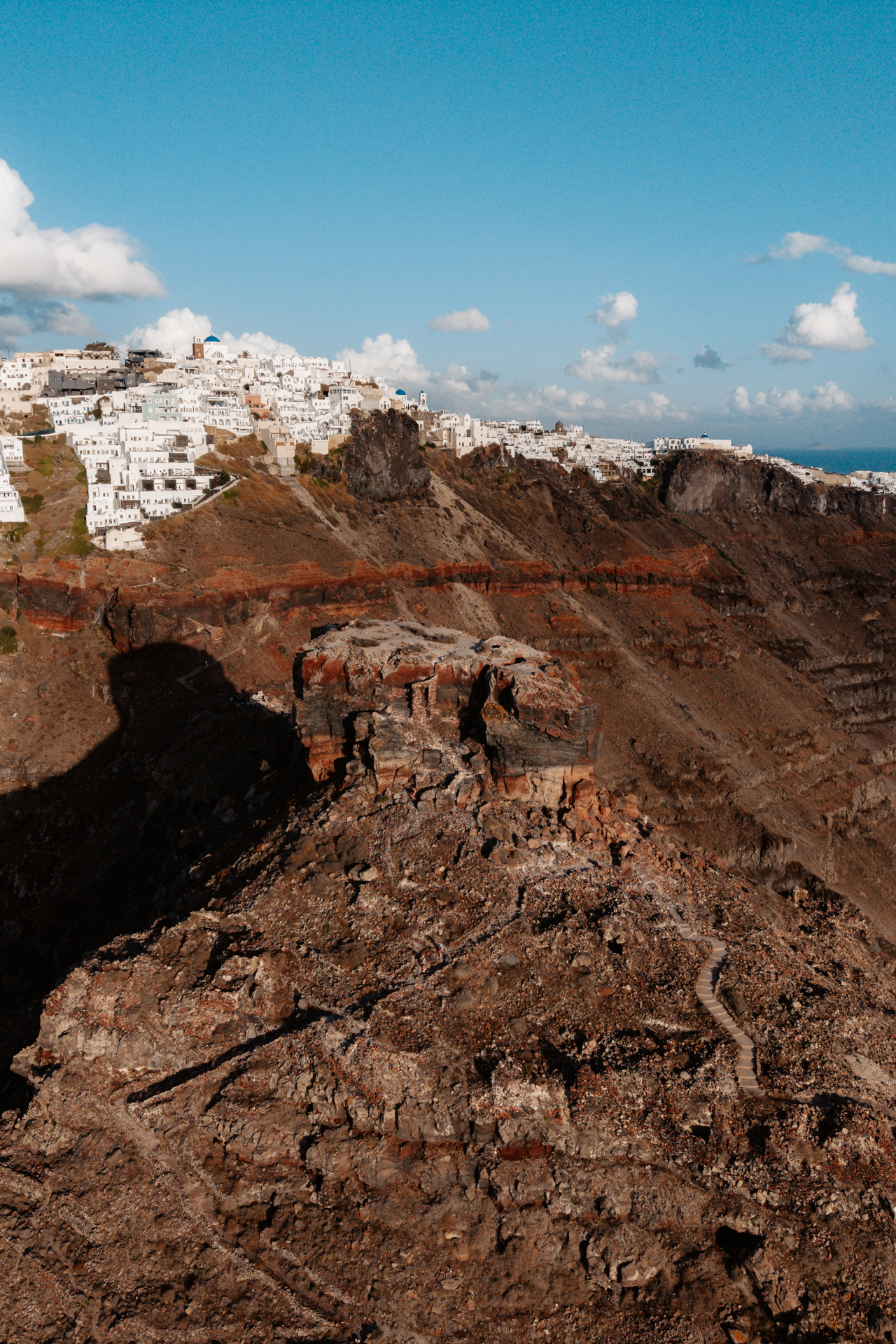 Skaros Rock Santorini with volcanic cliffs and white houses of Imerovigli above caldera