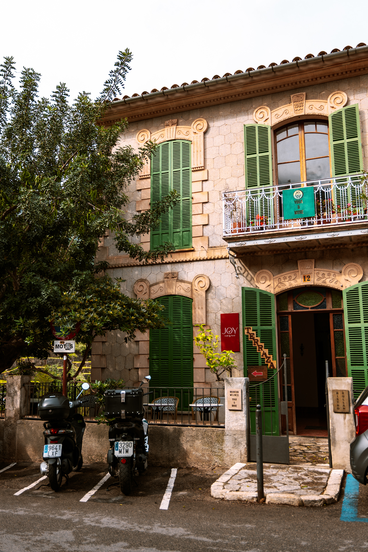 Traditional stone building with green shutters in Deià village, Mallorca, Spain