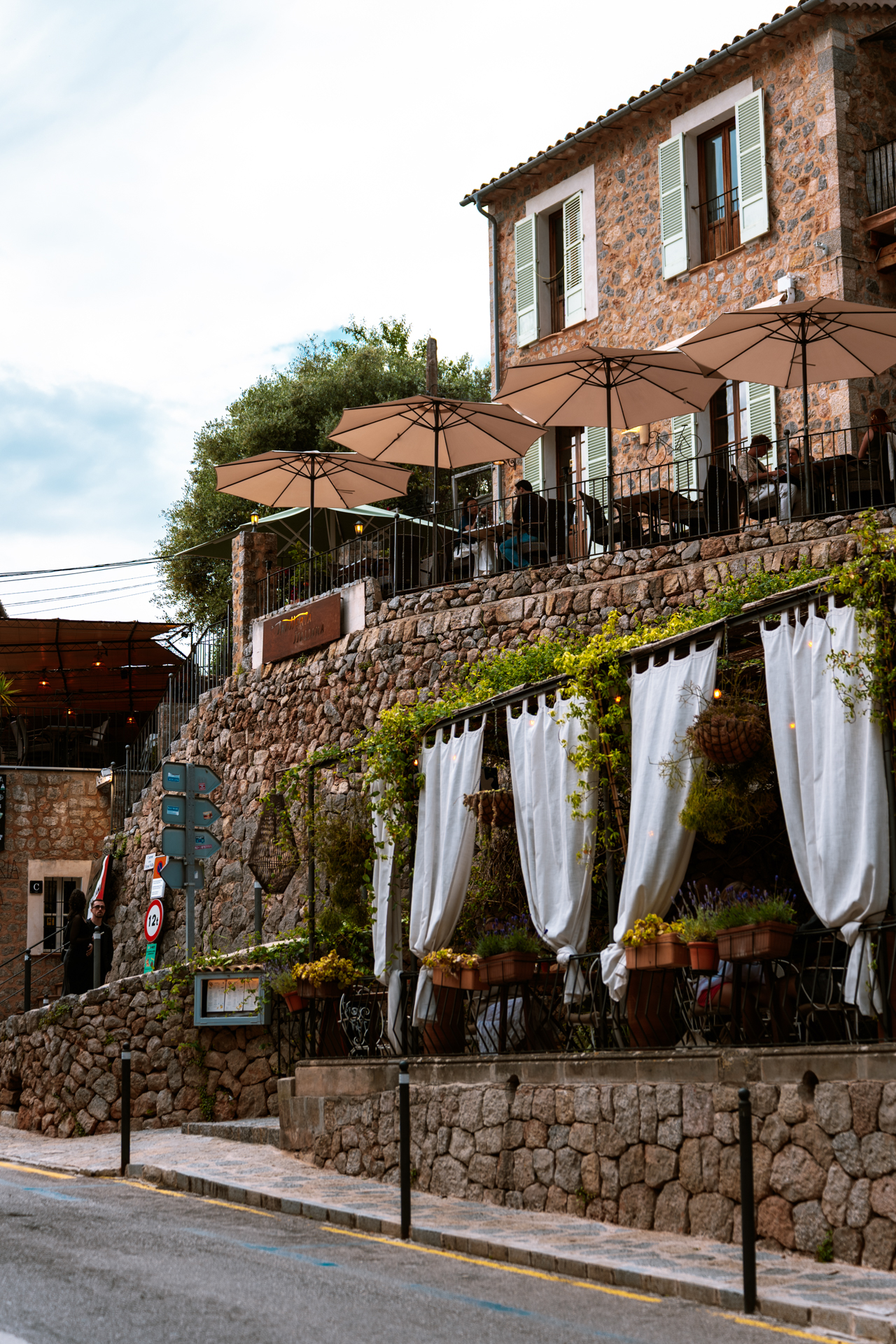 Elegant terraced restaurant and stone architecture in Deià, Mallorca