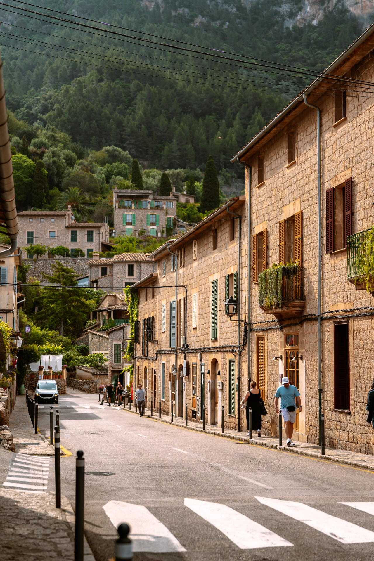 Scenic stone street in Deià, Mallorca, lined with traditional village houses and mountain views