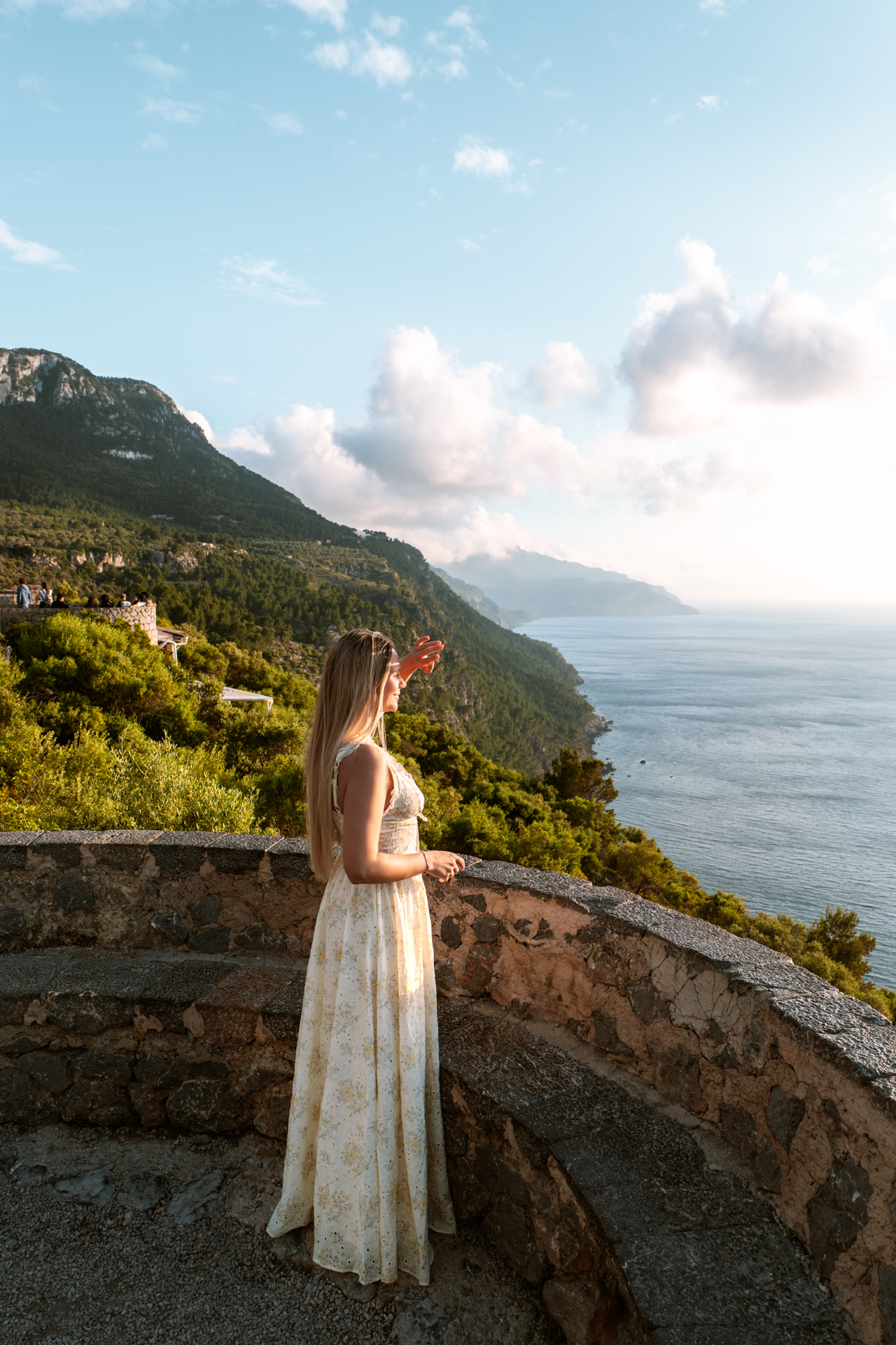 Woman enjoying sunset views over Sa Foradada coastline in Mallorca