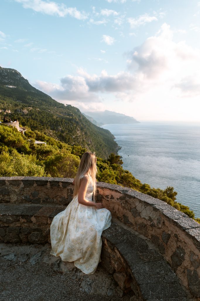 Woman overlooking Sa Foradada coastline in Mallorca at golden hour