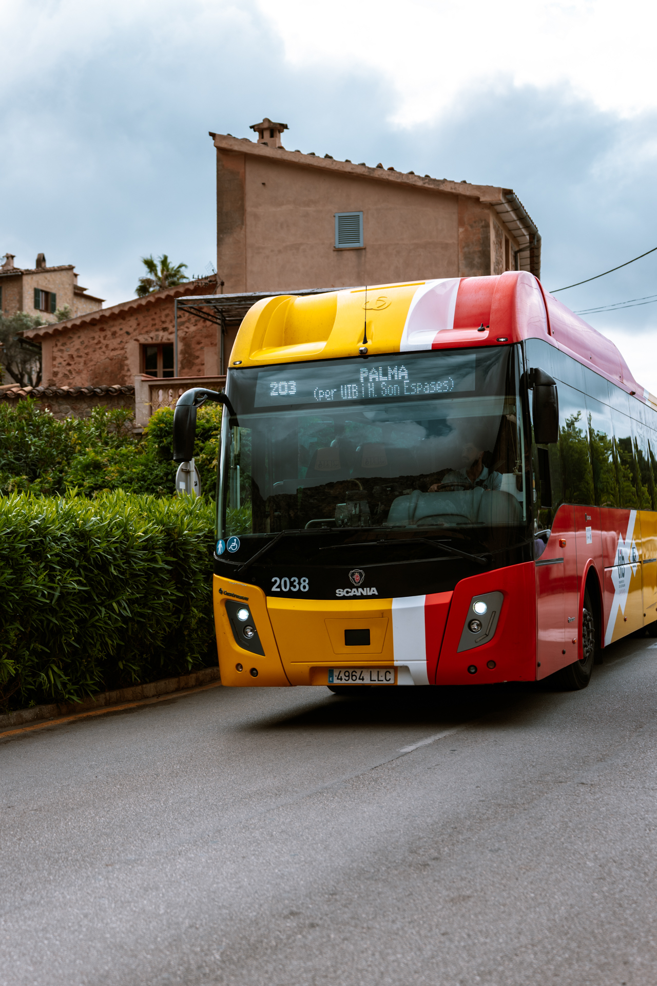 Red and yellow TIB bus in Deià, Mallorca, Spain