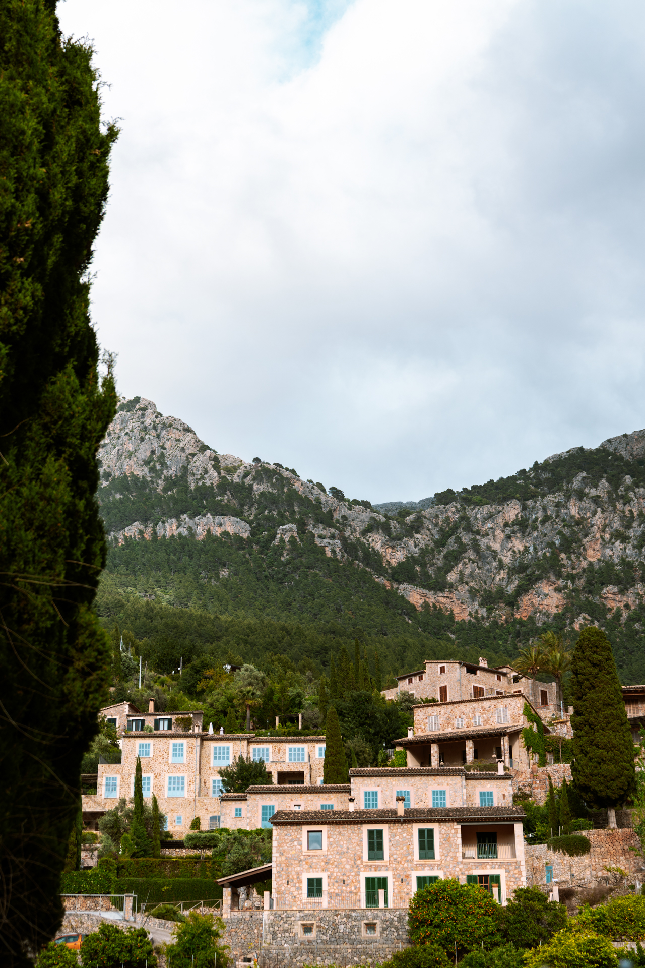 Stone villas beneath the dramatic Tramuntana mountains in Deià, Mallorca, Spain