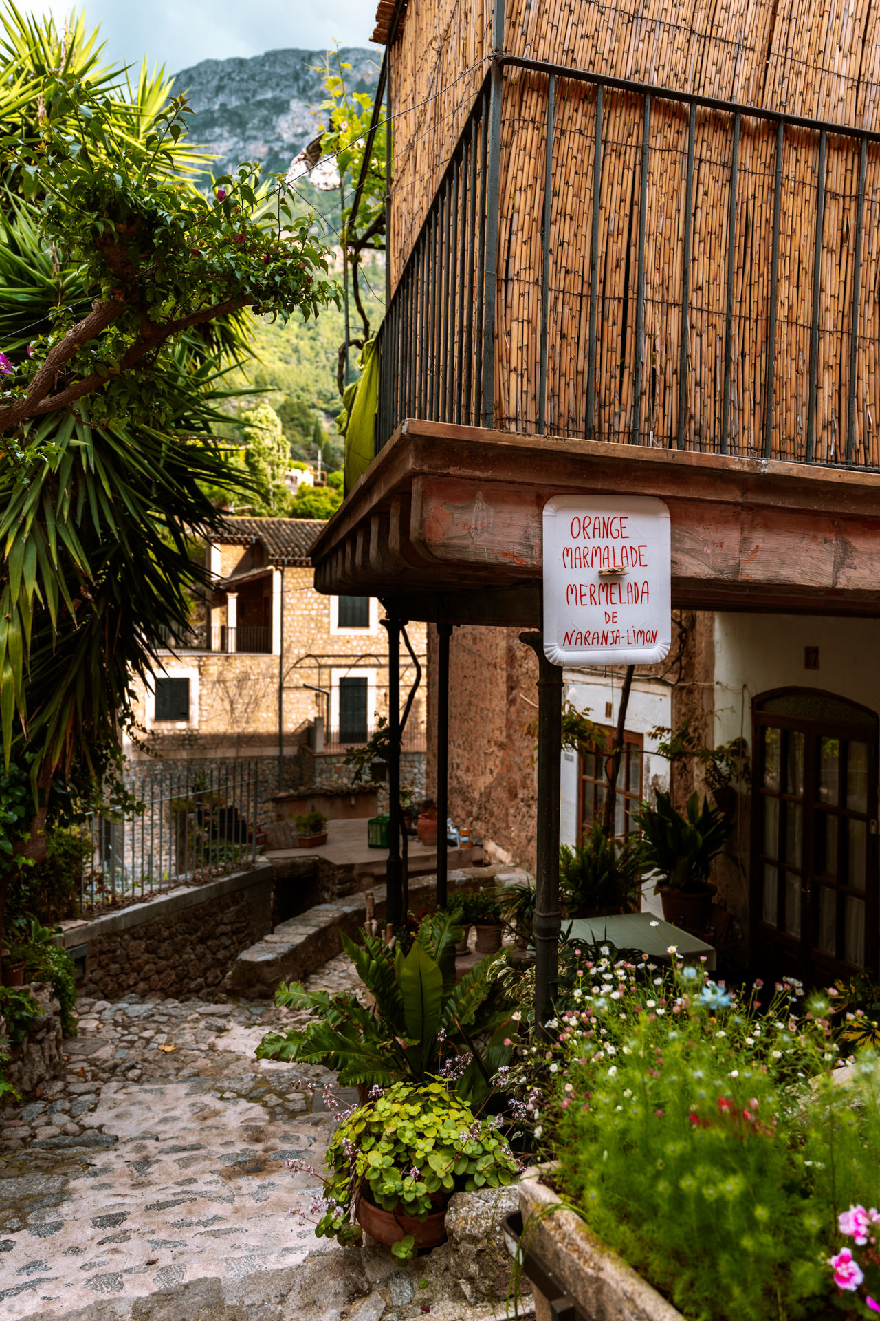 Charming stone alley with a handmade orange marmalade sign in Deià, Mallorca, Spain