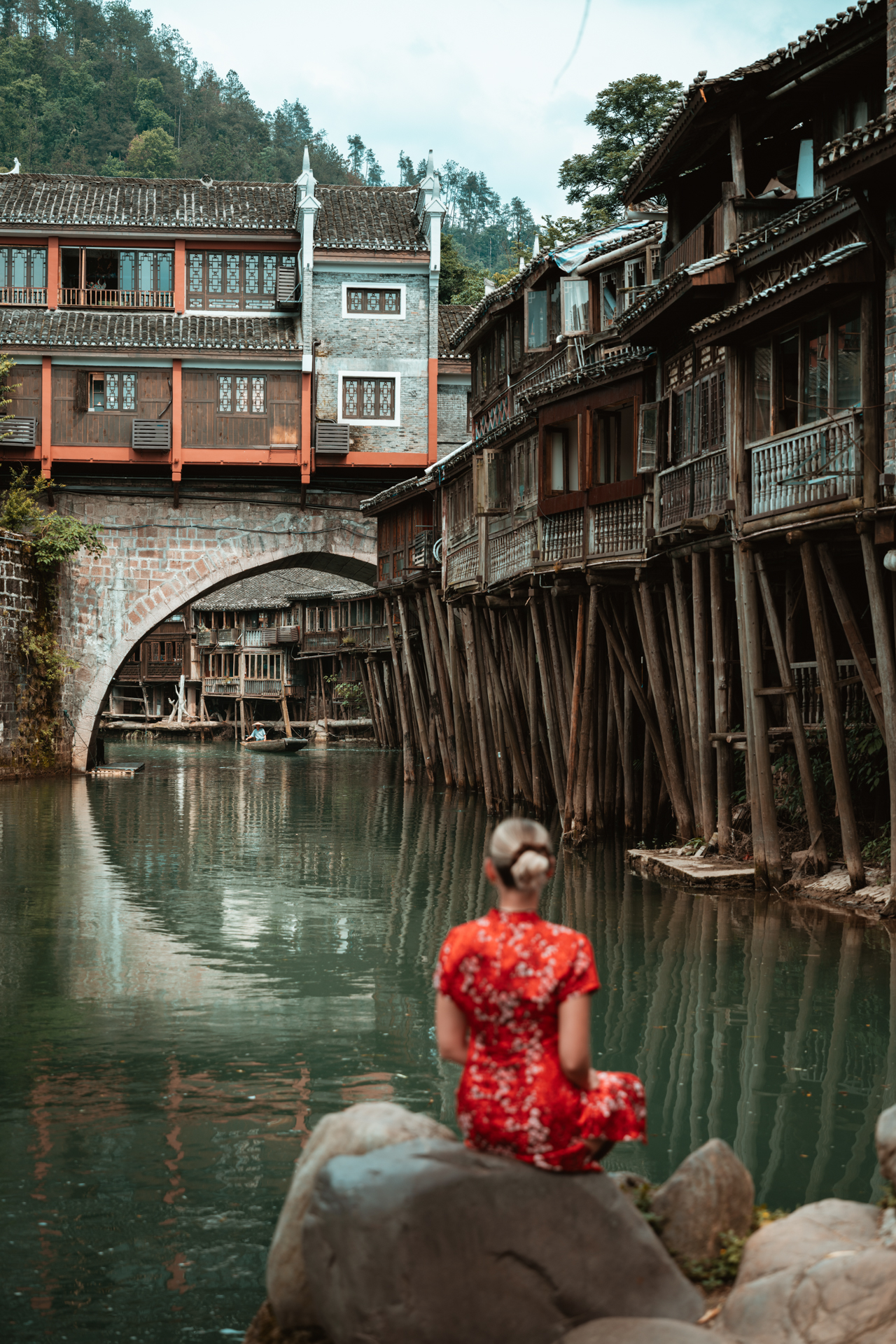 Fenghuang Ancient Town Fenghuang Ancient Town in Hunan, China, with traditional wooden stilt houses, and a stone bridge.