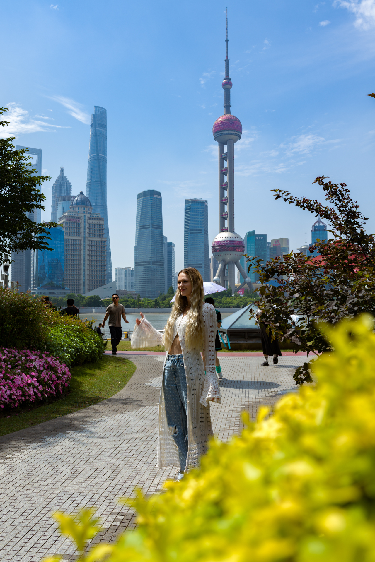 Shanghai Woman in Shanghai with the Oriental Pearl Tower and Pudong skyline in the background.