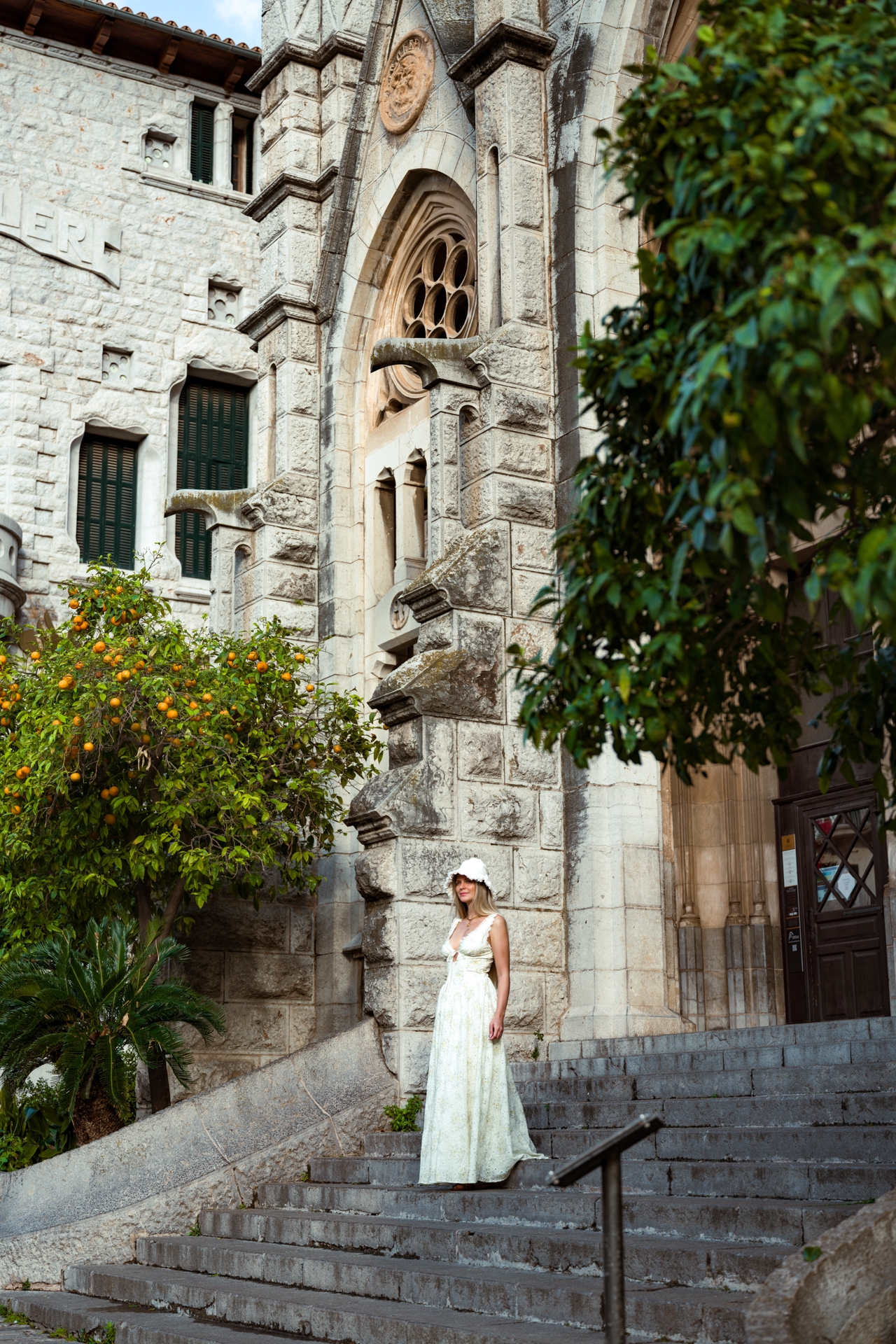 Woman standing beside Sant Bartomeu Church in Sóller, Mallorca.