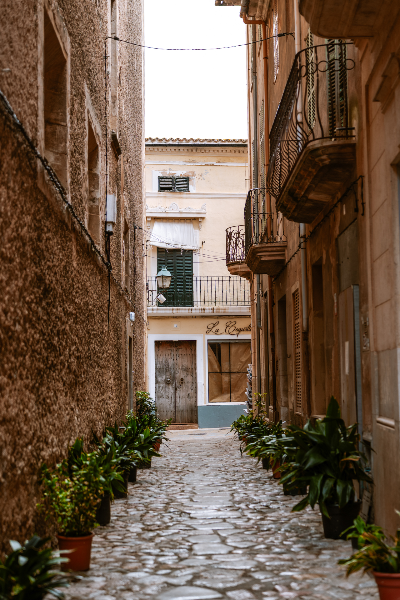 Narrow cobblestone alley in Pollença Old Town, Mallorca