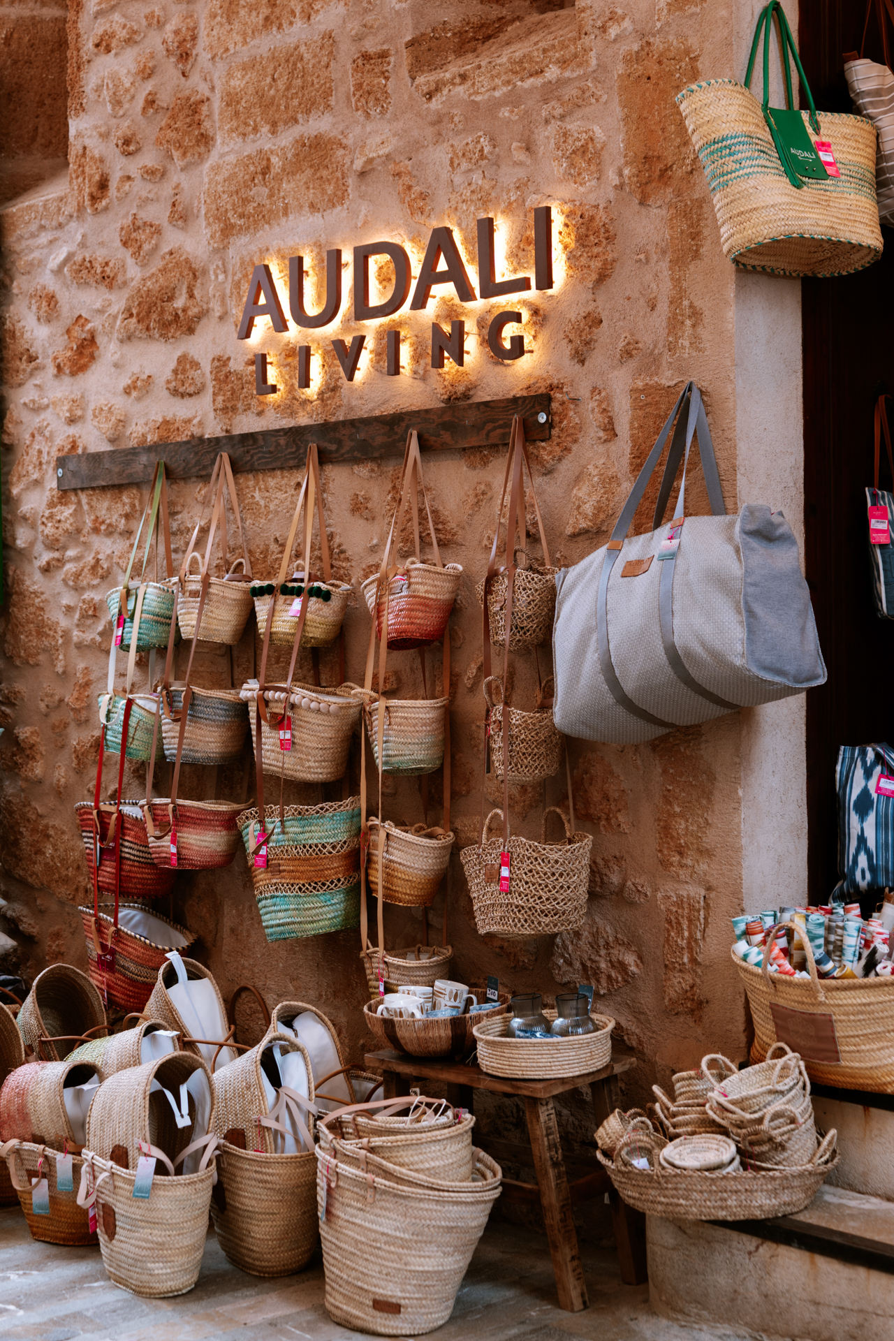 Handmade straw bags displayed outside a boutique in Alcúdia Old Town.