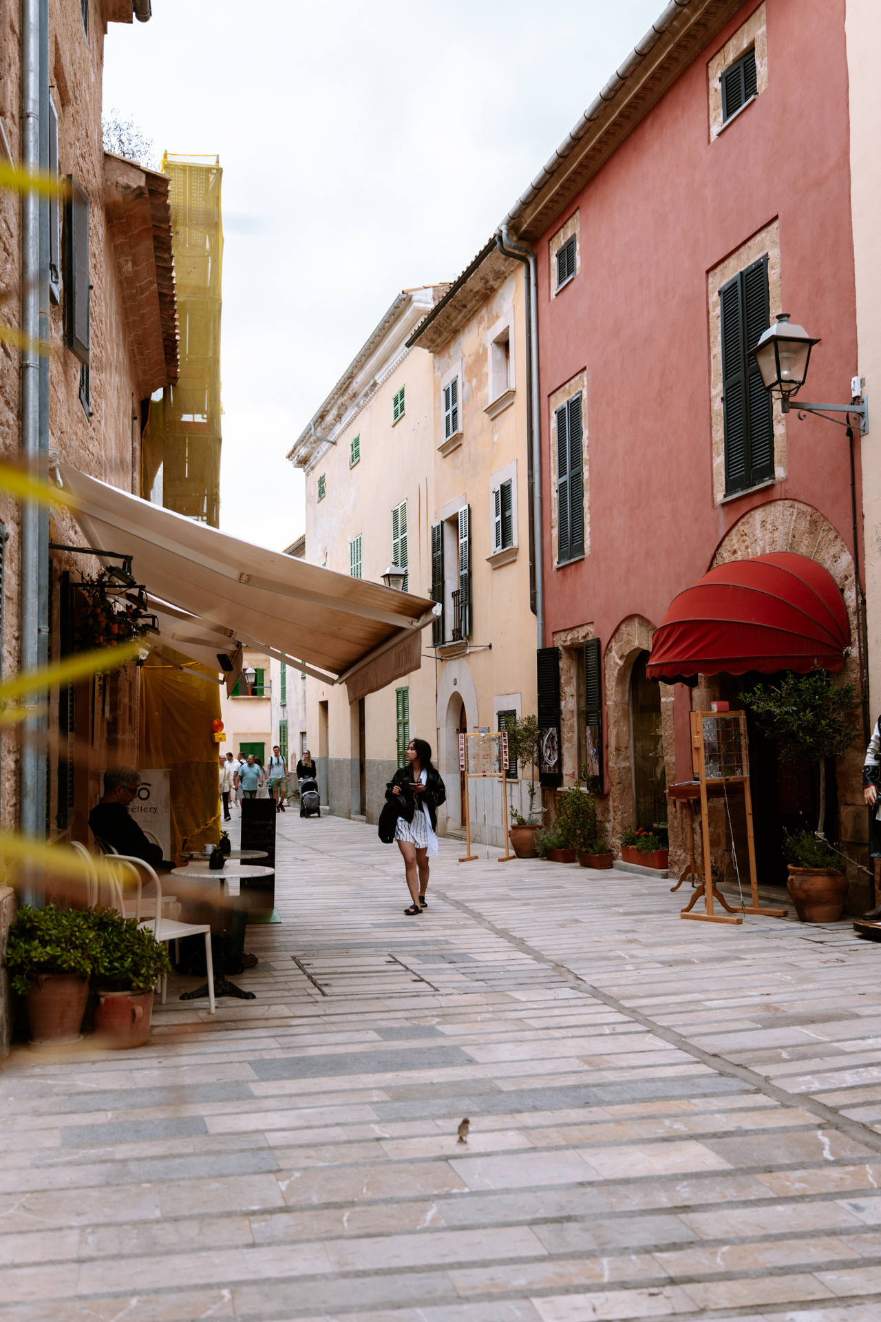 Colorful boutique street with vintage shops in Alcúdia Old Town, Mallorca.