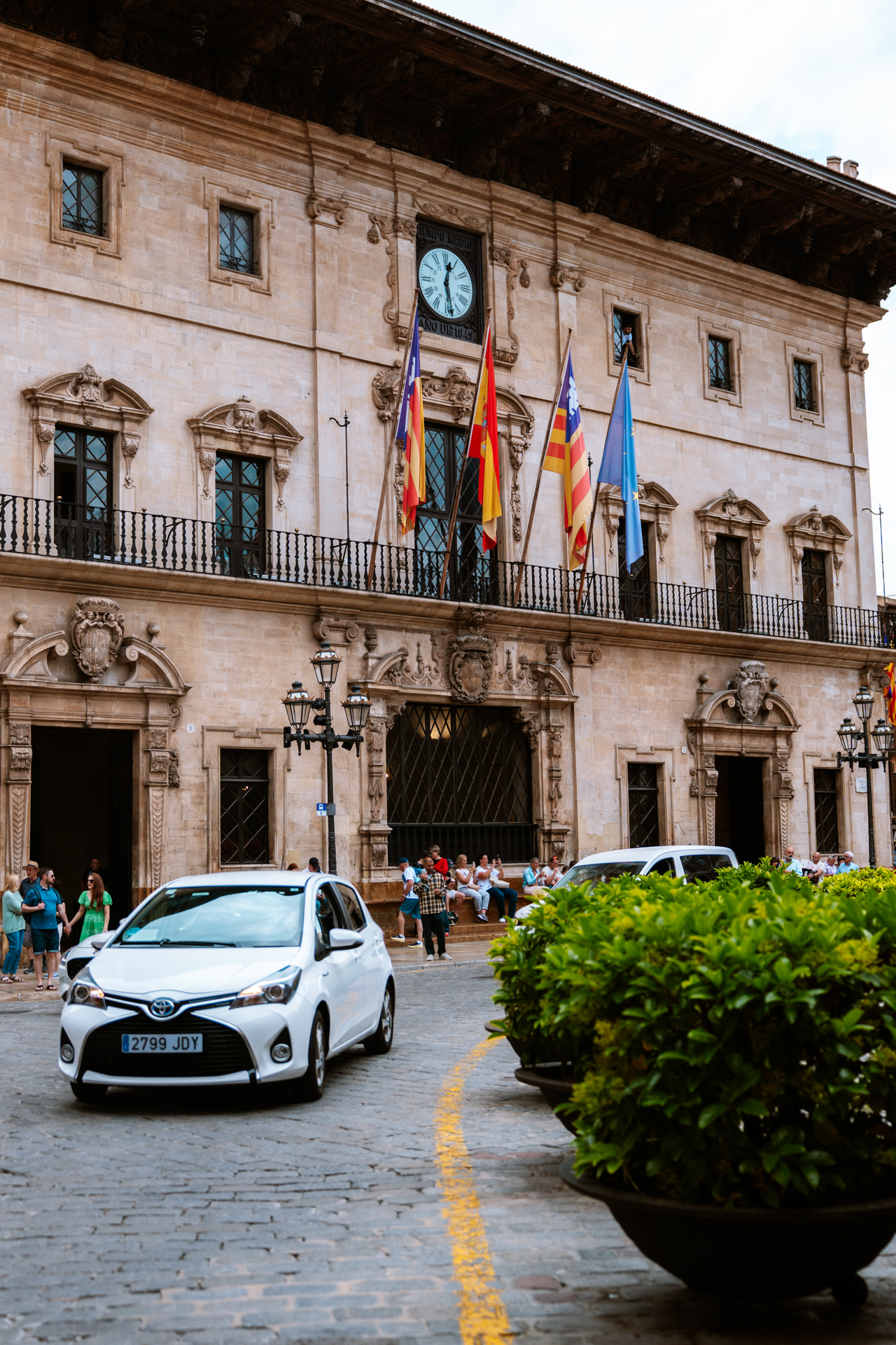 Historic town hall building with flags in the old town of Palma de Mallorca, Spain.