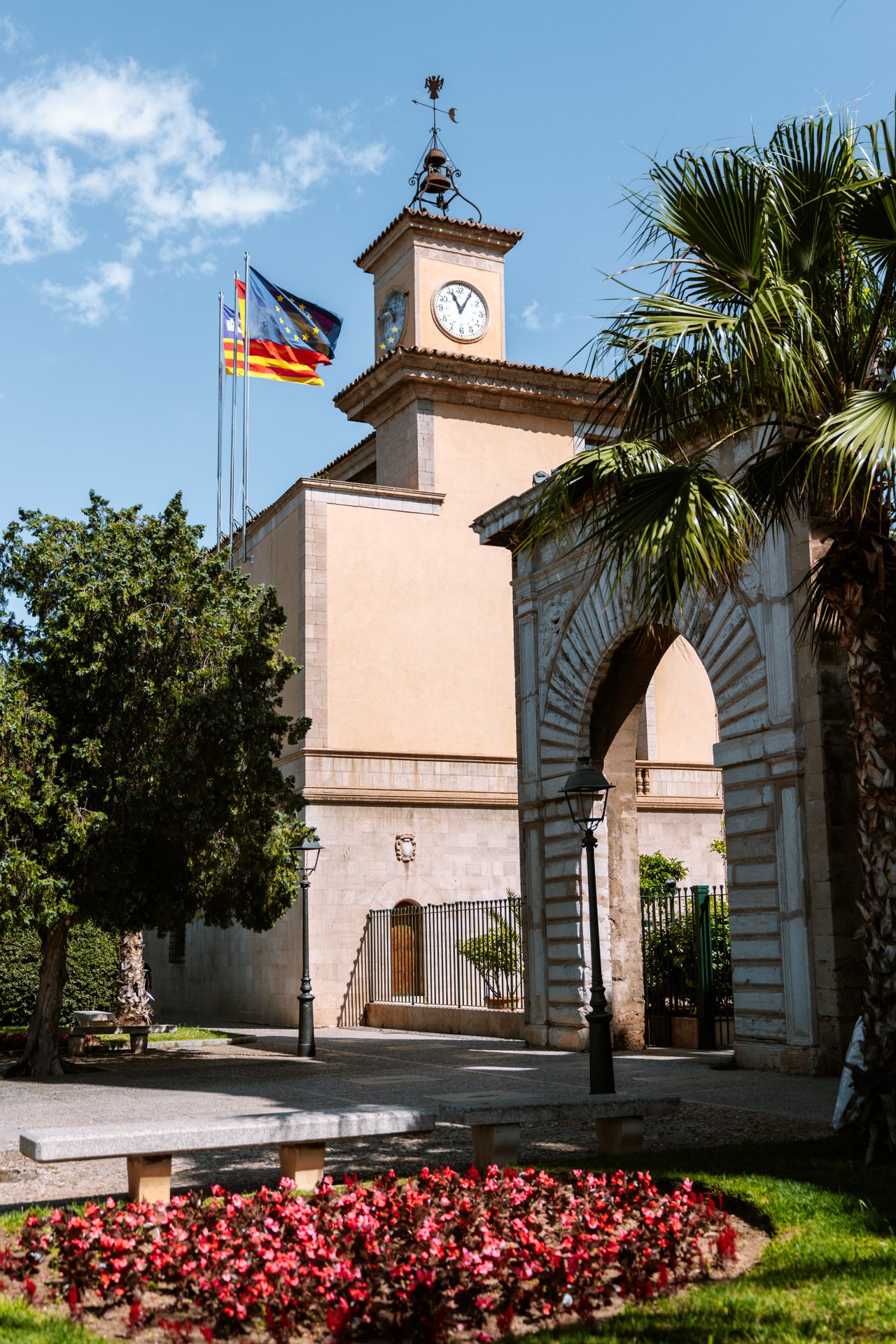 Clock tower and historic archway near Palma Cathedral in Mallorca, Spain.