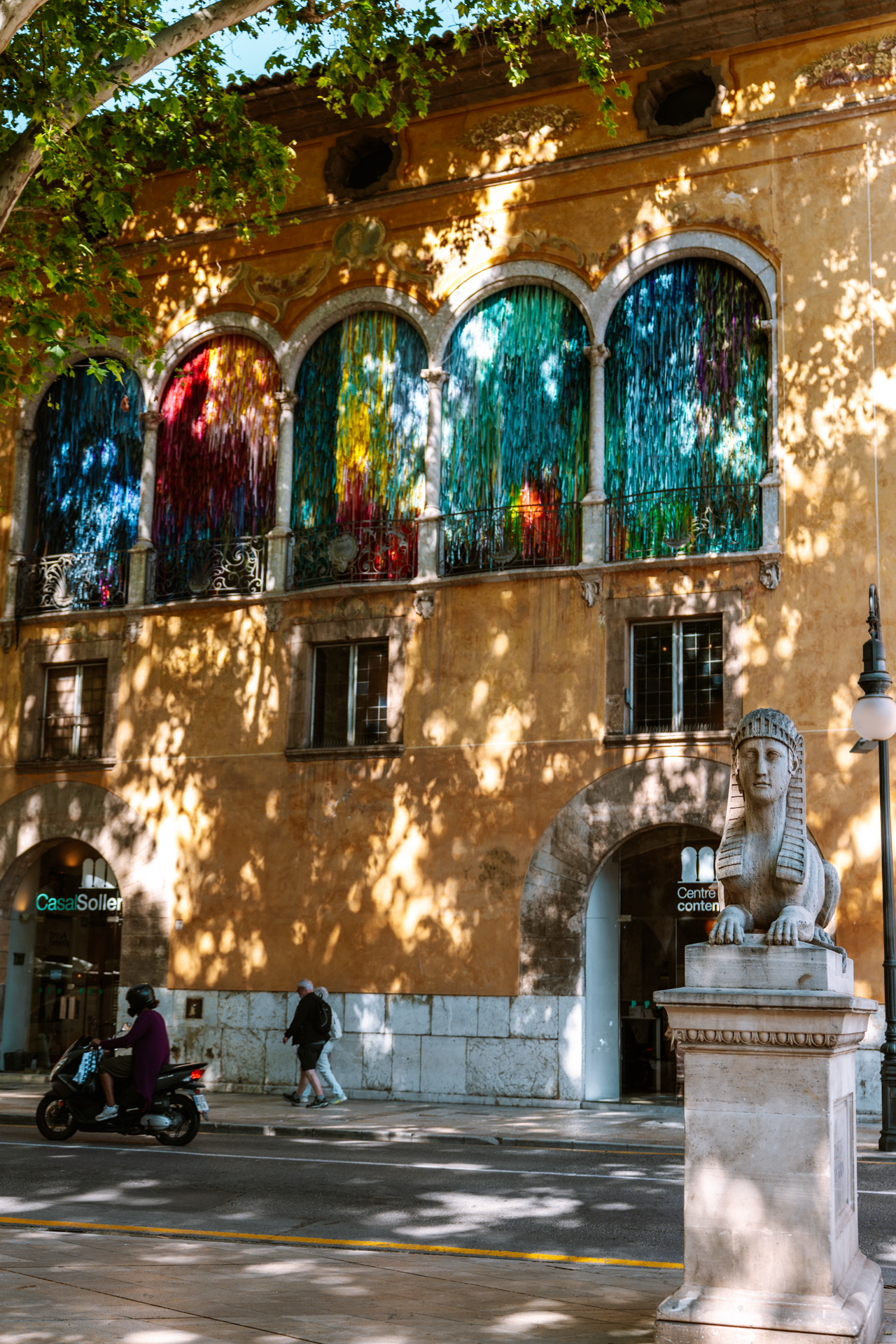 Historic Palma building with colorful window displays in Mallorca, Spain.