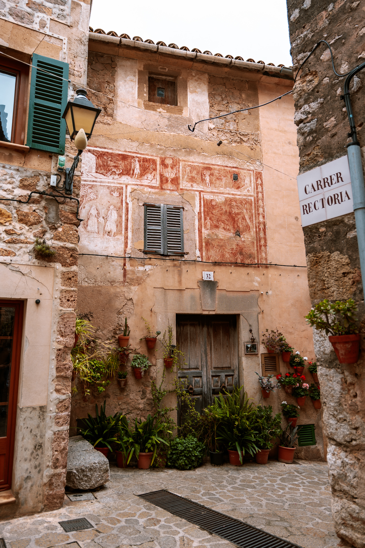 Historic stone house with murals on Carrer Rectoria in Valldemossa