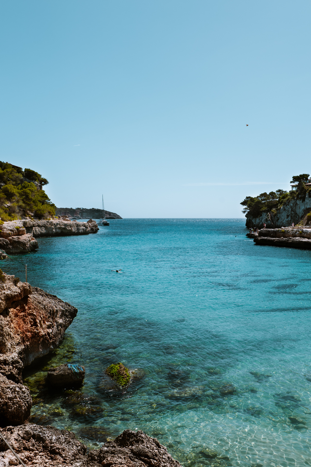 Panoramic view of Cala Llombards bay with clear turquoise sea