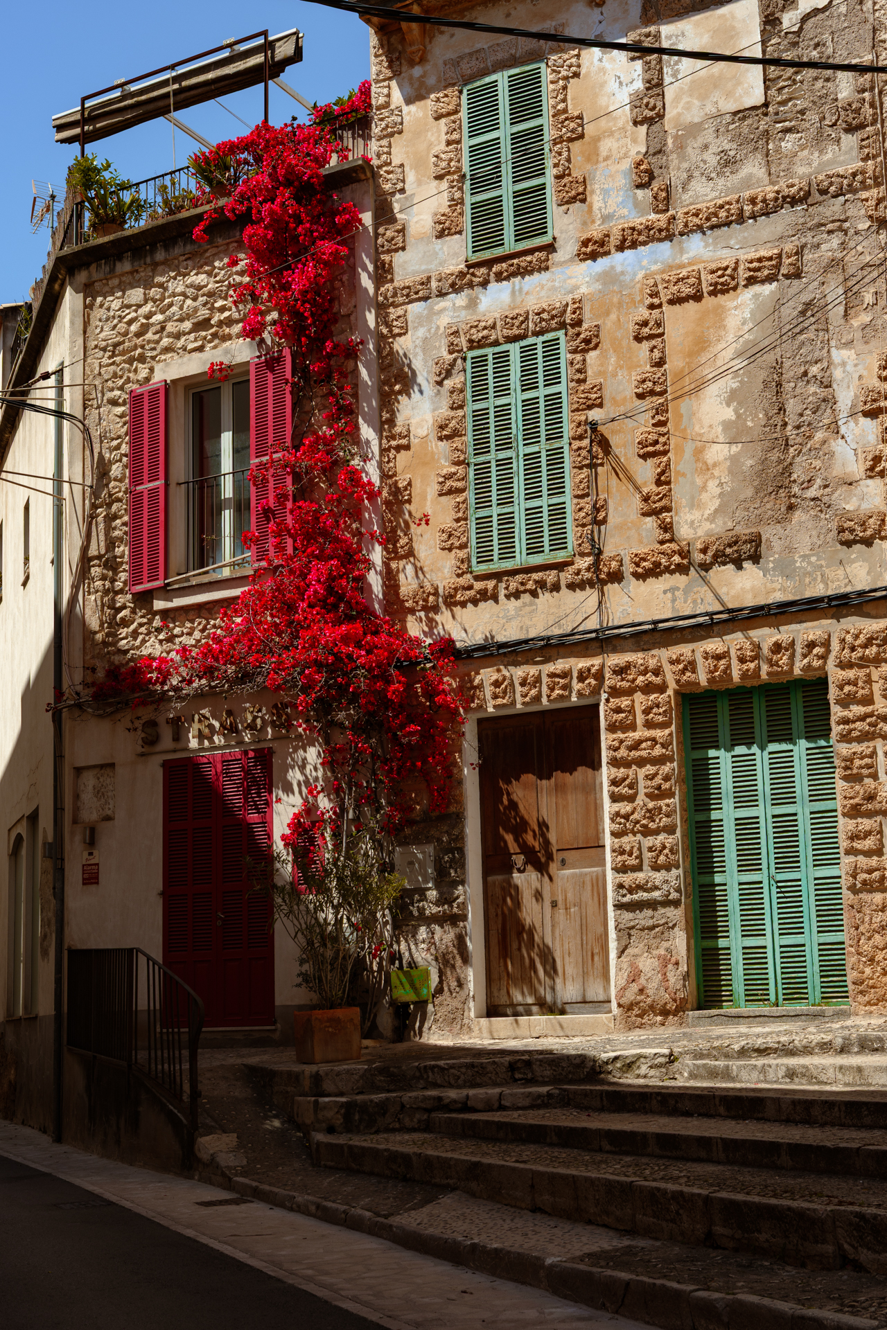 Traditional stone house with red bougainvillea in Felanitx Old Town, Mallorca