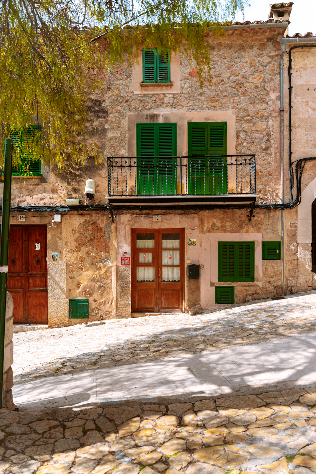 Traditional stone house with green shutters in Valldemossa, Mallorca