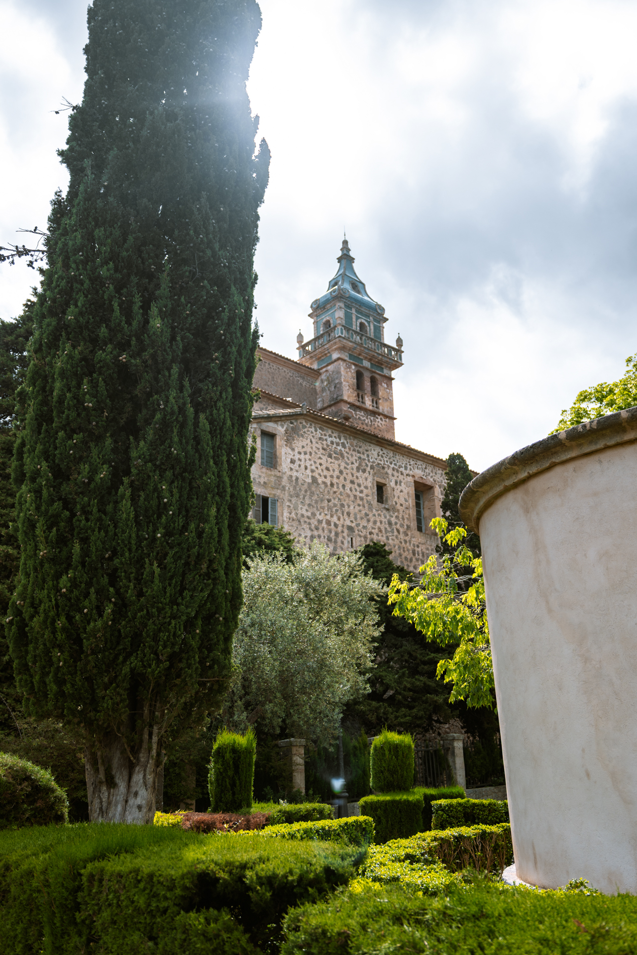 Cartoixa de Valldemossa monastery surrounded by lush gardens in Mallorca