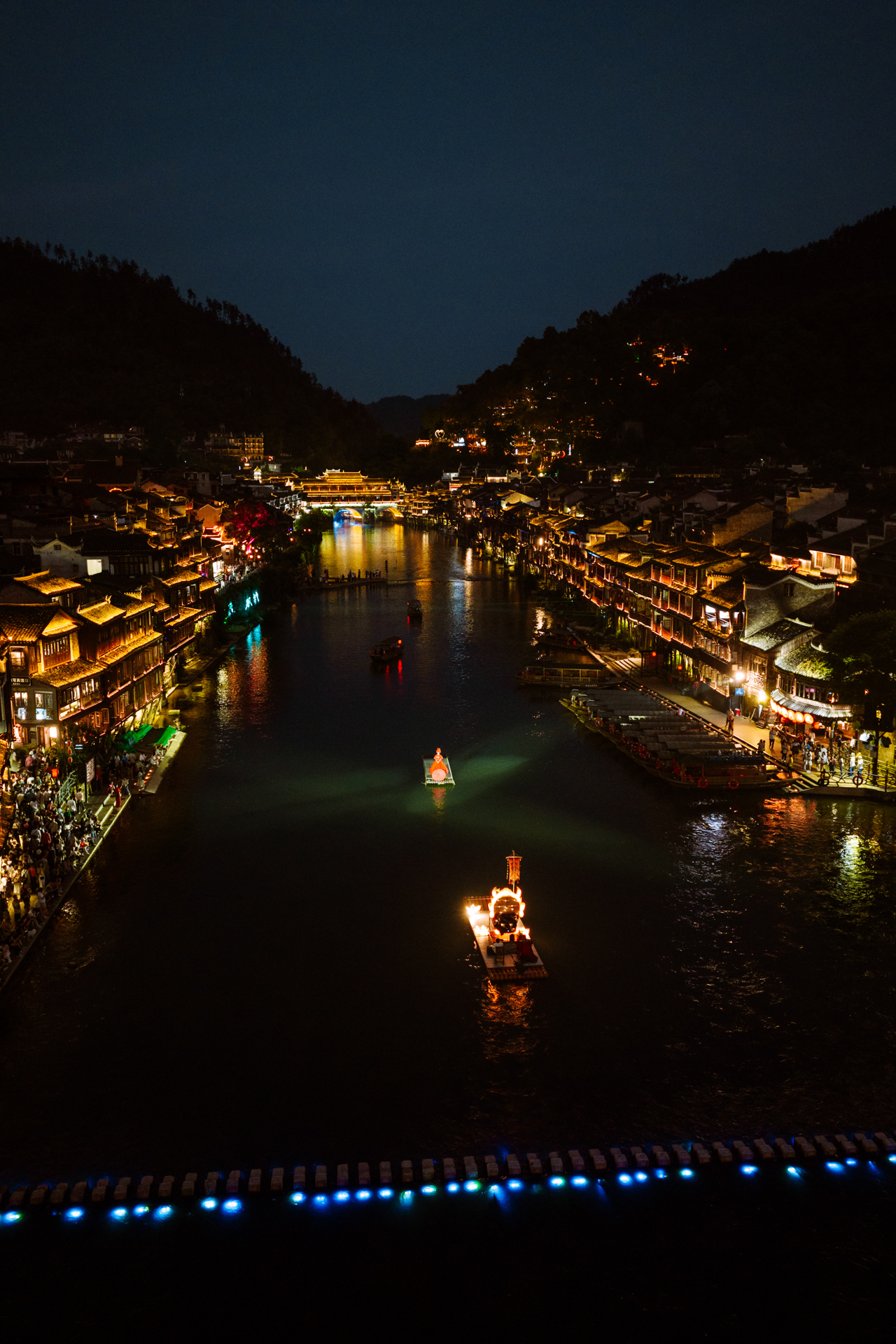 Fenghuang Ancient Town illuminated at night along the Tuojiang River, China