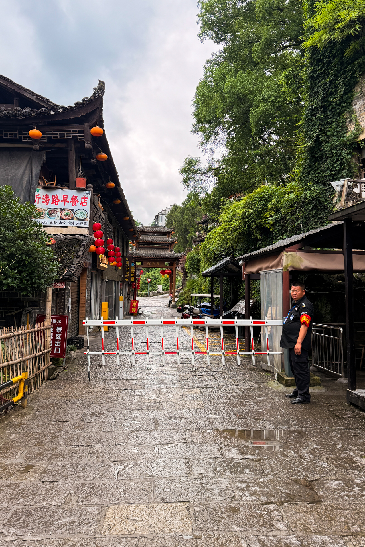 Entrance street to Furong Ancient Town with traditional buildings and red lanterns.