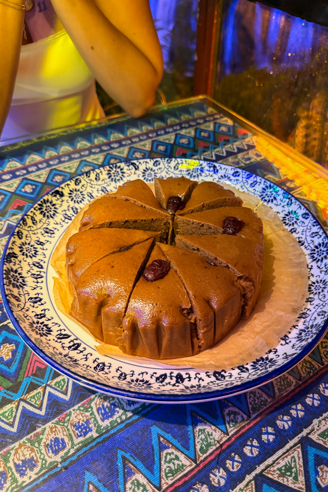Traditional brown sugar rice cake served at a restaurant in Furong Ancient Town, China.