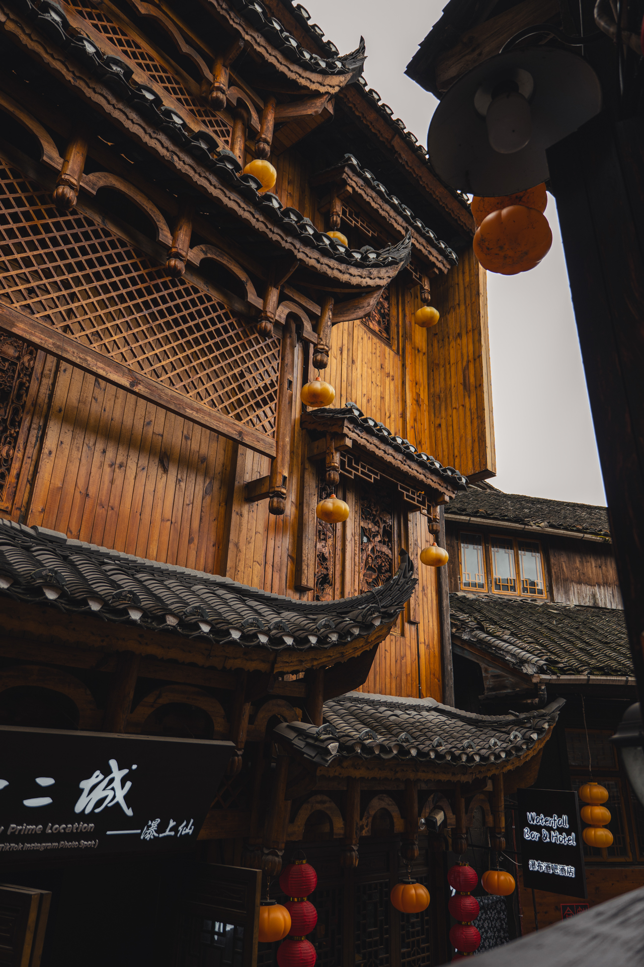 Traditional wooden architecture and hanging lanterns in Furong Ancient Town, Hunan, China.