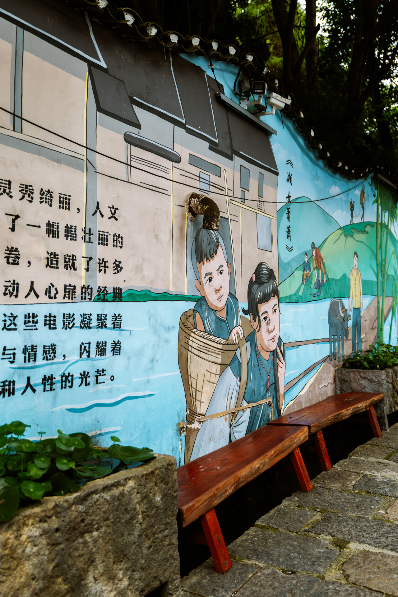 Colorful mural along a stone path in Furong Ancient Town, Hunan, China.
