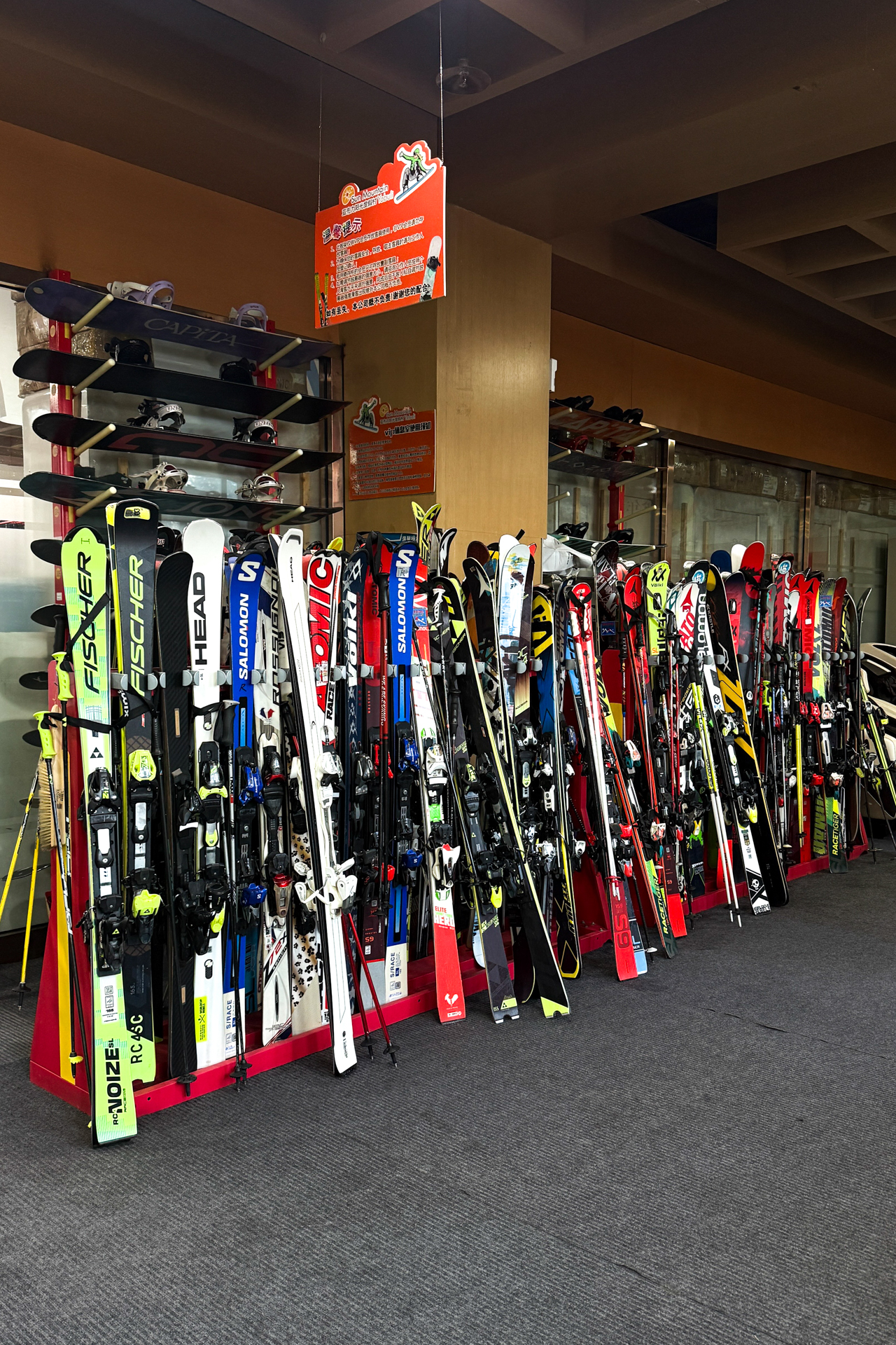 Rows of skis and snowboards available for rental at a Harbin ski resort.