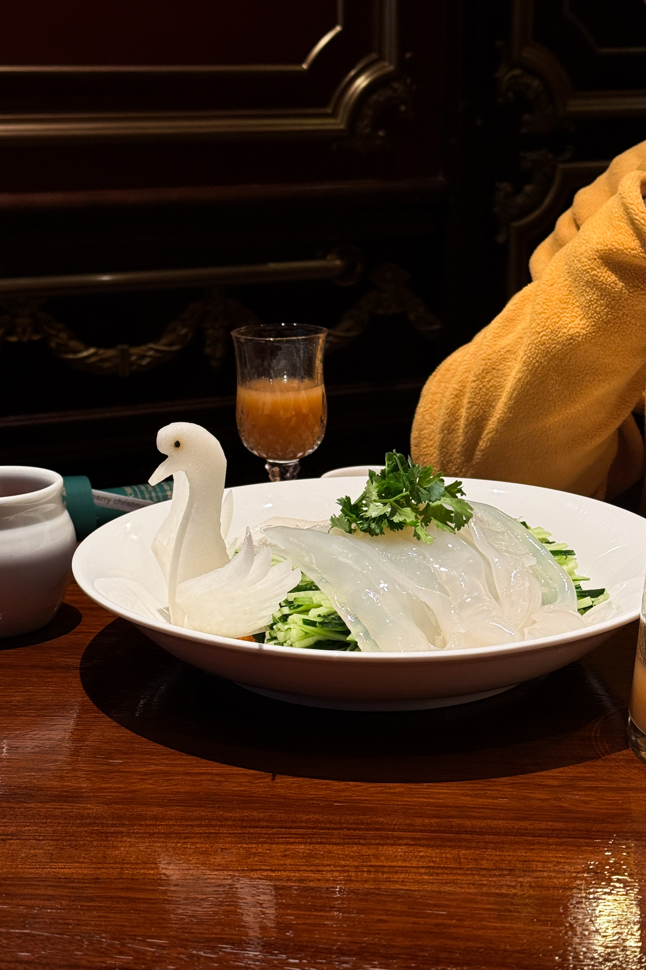 Traditional Harbin dish served with sliced vegetables and decorative swan garnish.