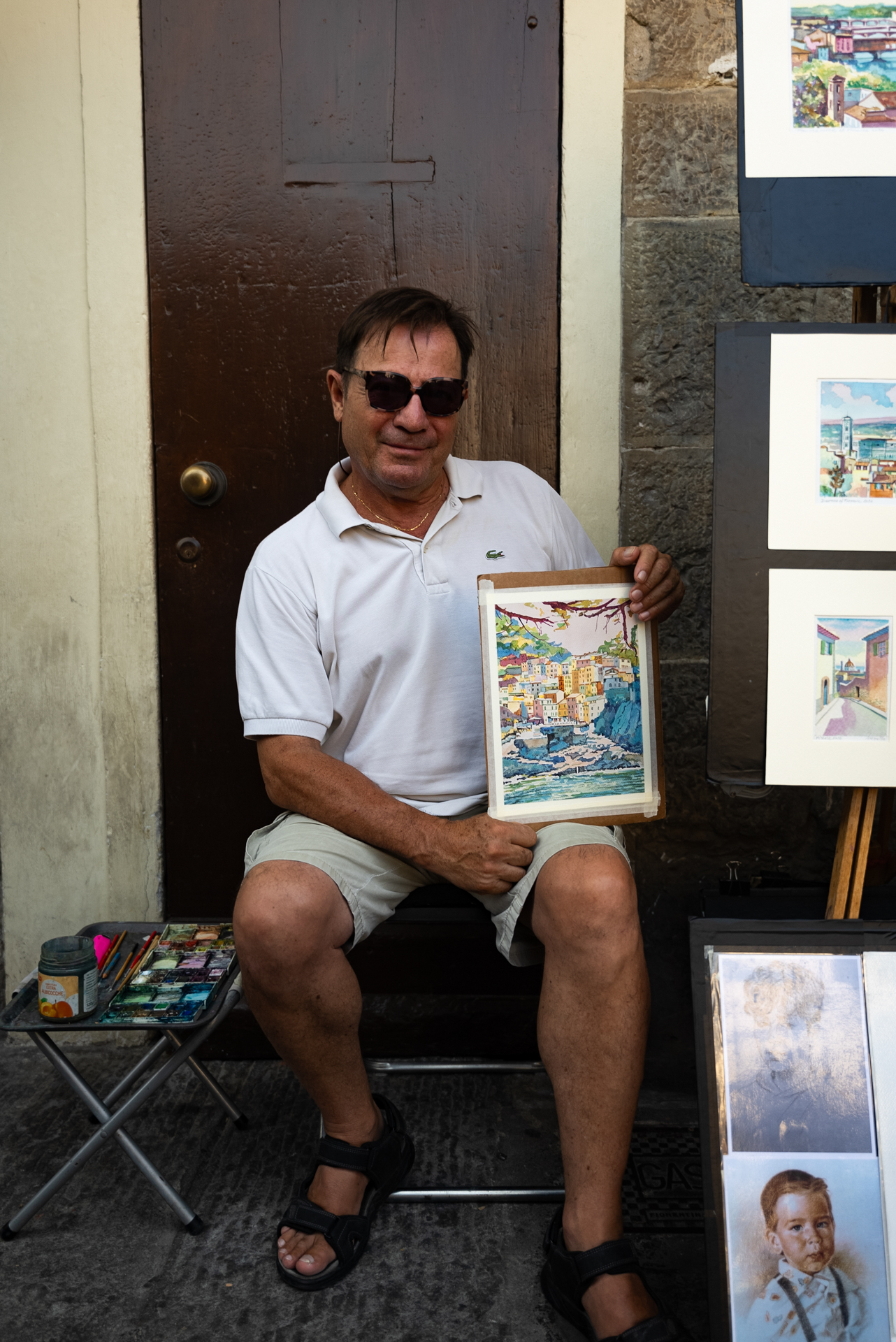 Street artist displaying watercolor paintings in Florence