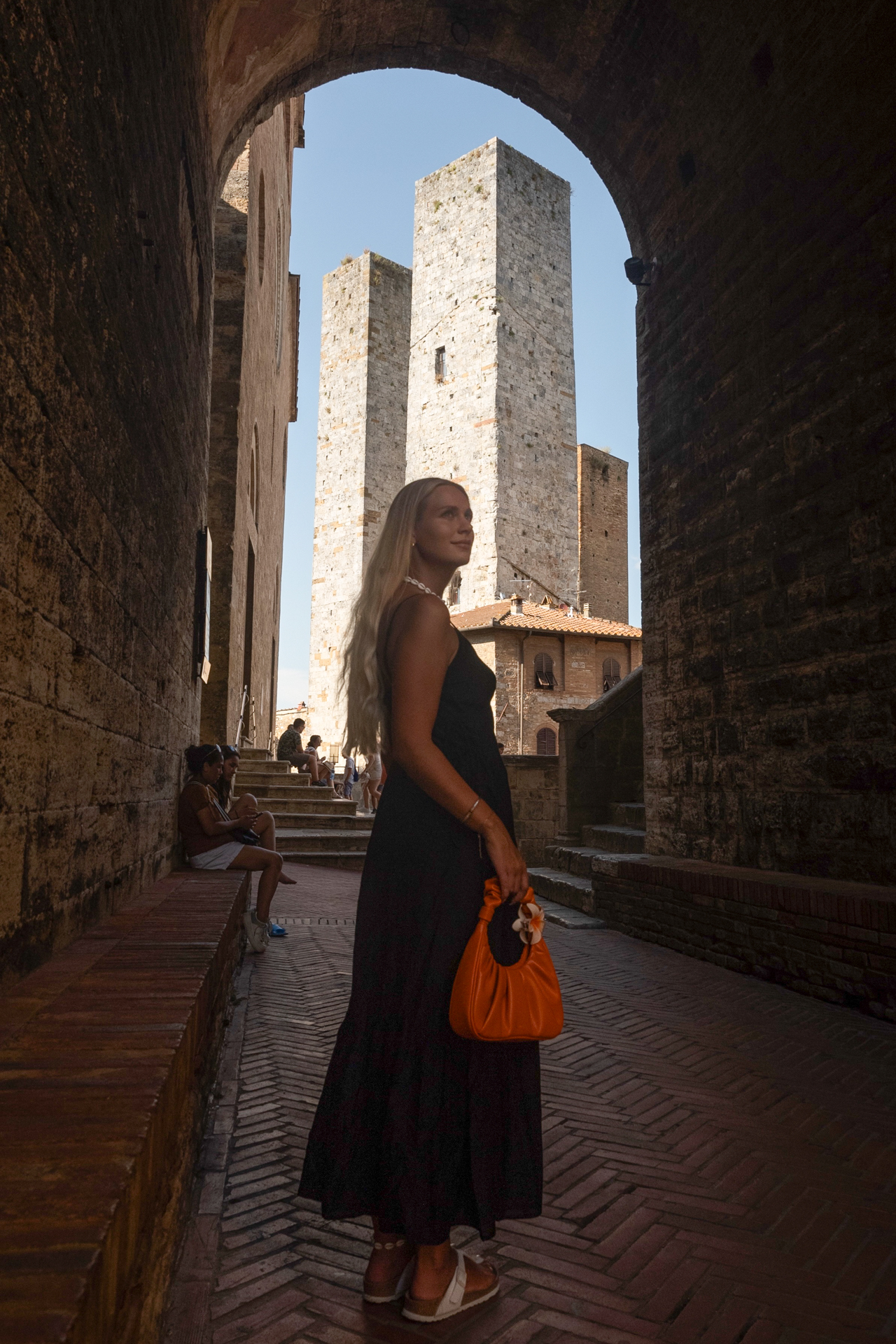 Medieval towers framed by an archway in San Gimignano, Tuscany