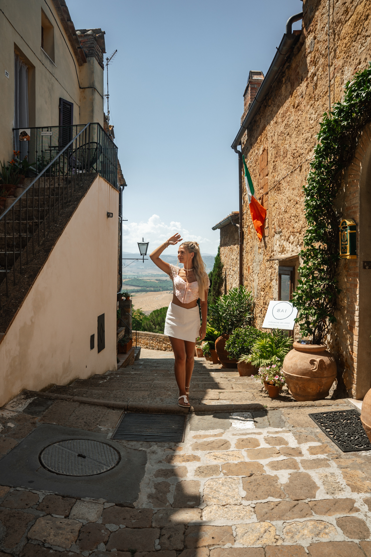 Walking through a charming stone street in Pienza, Tuscany