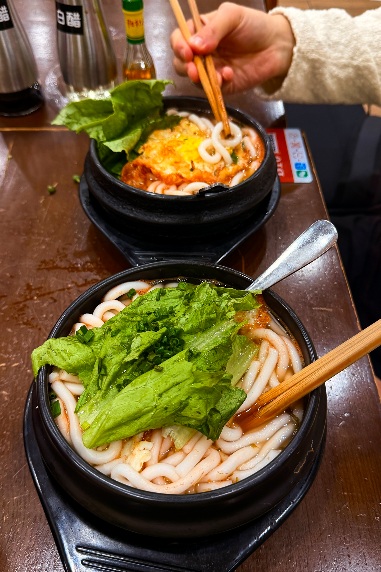 Bowls of noodles and vegetables at a local restaurant in Zhangjiajie, China.