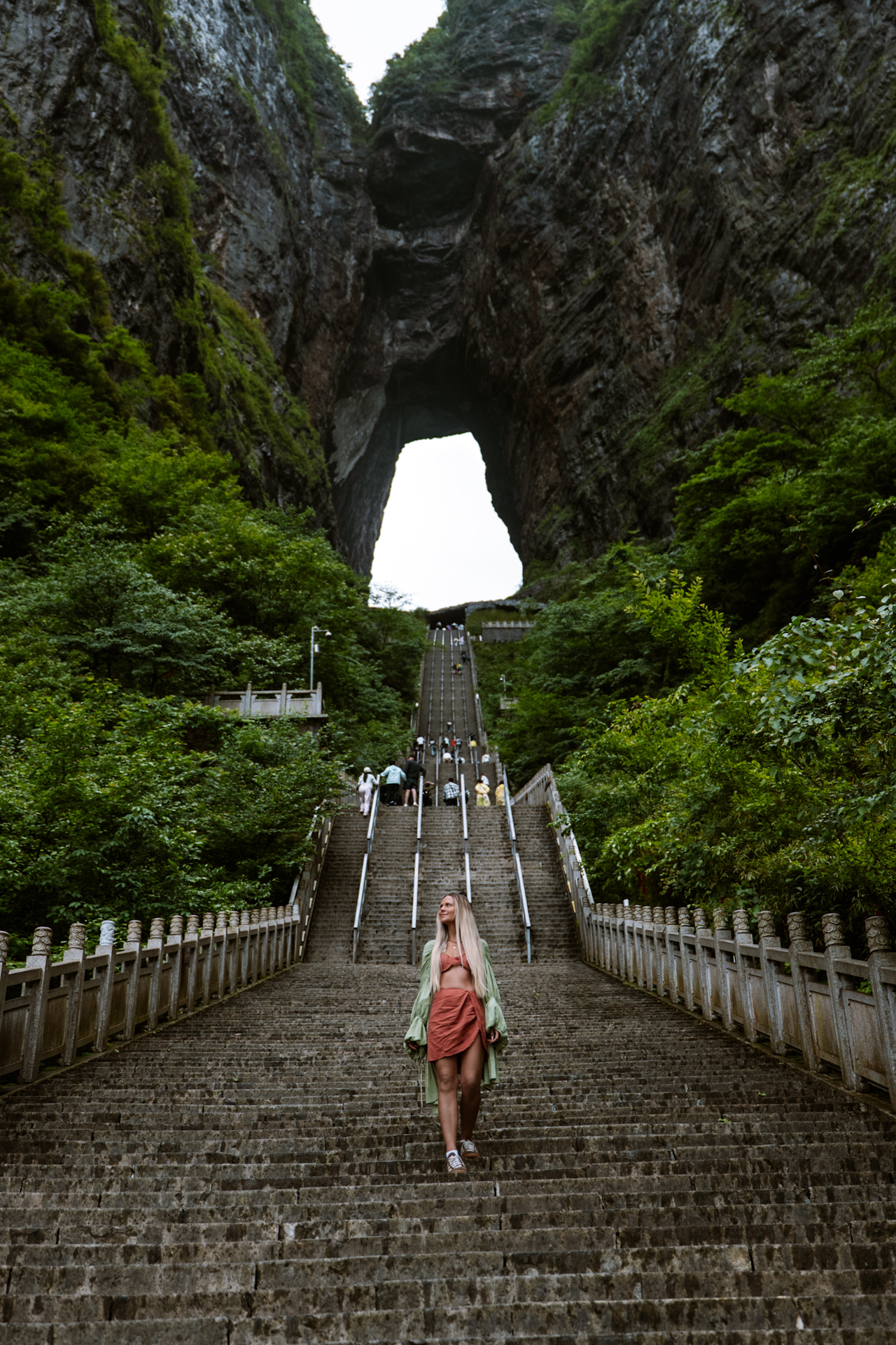 Woman walking down the 999 Steps beneath Heaven’s Gate at Tianmen Mountain, Zhangjiajie.