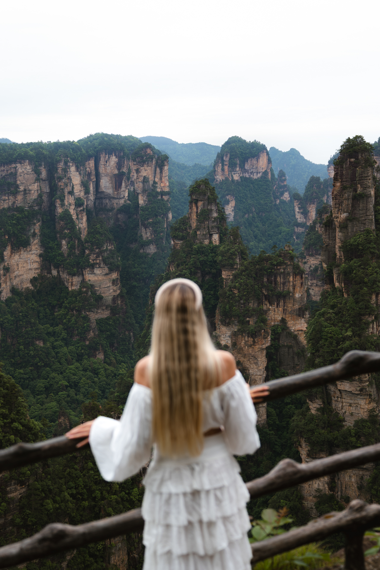 Woman overlooking the sandstone peaks of Zhangjiajie National Forest Park, China.